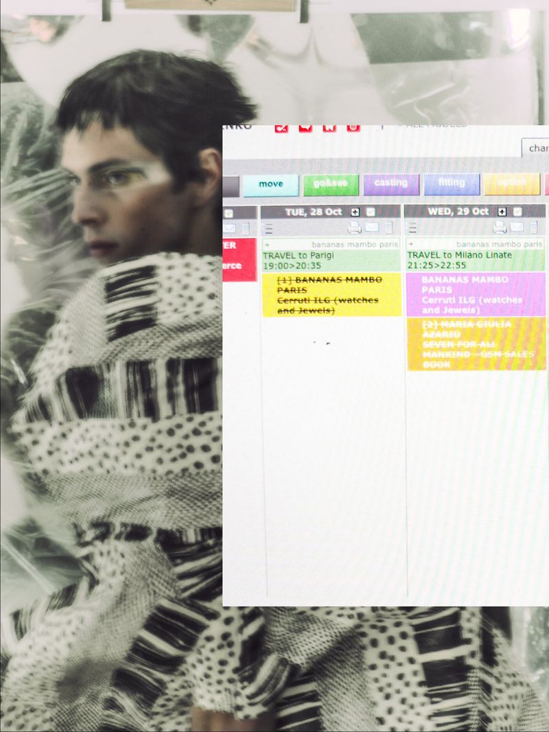 Fashionable adult male glances left, wearing printed sweater. Digital display shows schedules. Editorial fashion and technology concept.