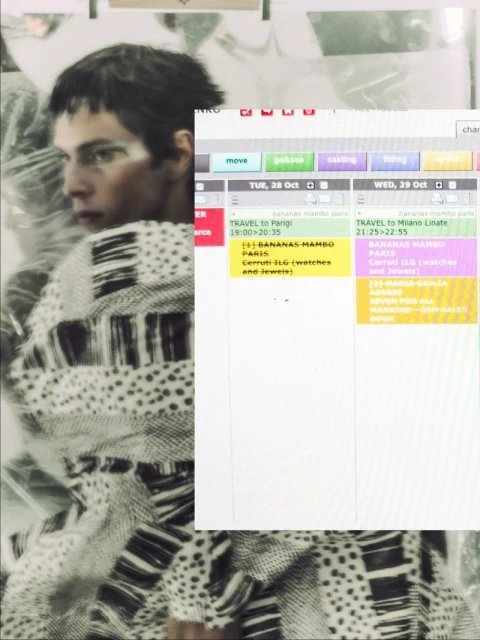 Fashionable adult male glances left, wearing printed sweater. Digital display shows schedules. Editorial fashion and technology concept.