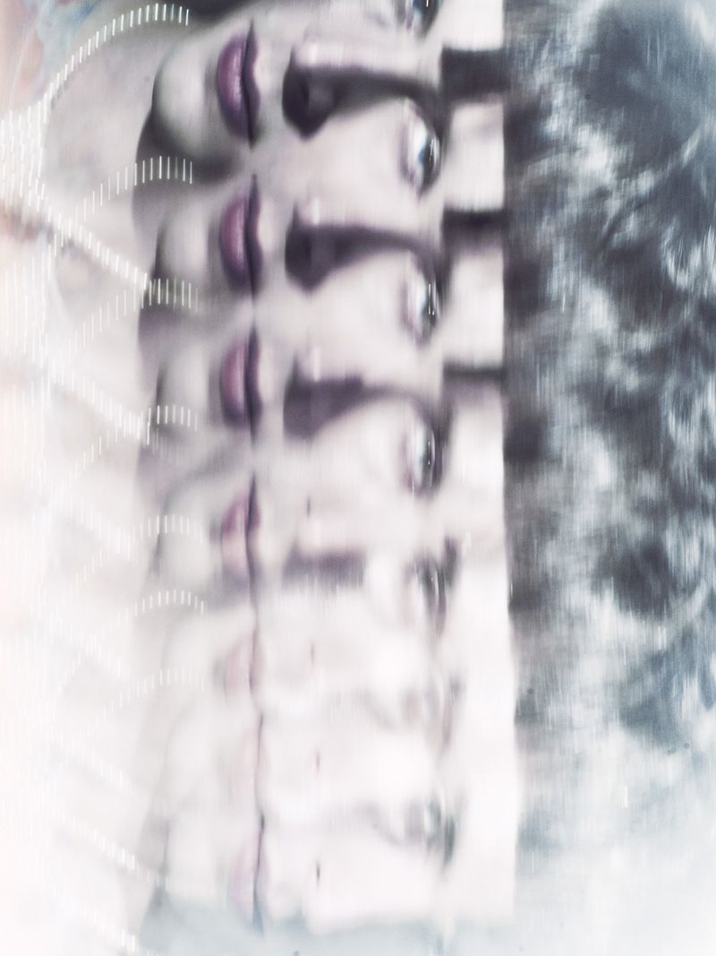 Abstract image of a woman's face with multiple exposures, featuring purple lipstick and a blurred, ethereal effect. Soft, filtered lighting.