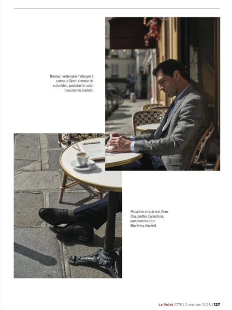 Man in a blazer sitting at an outdoor cafe table with coffee and a document, bathed in warm sunlight, with a city street background.