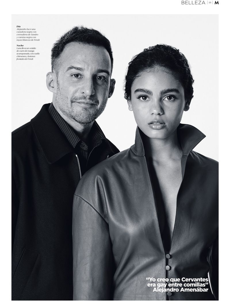 Editorial portrait of Alejandro Amenábar and Luna Berroa posing in dark outerwear against a white studio background.