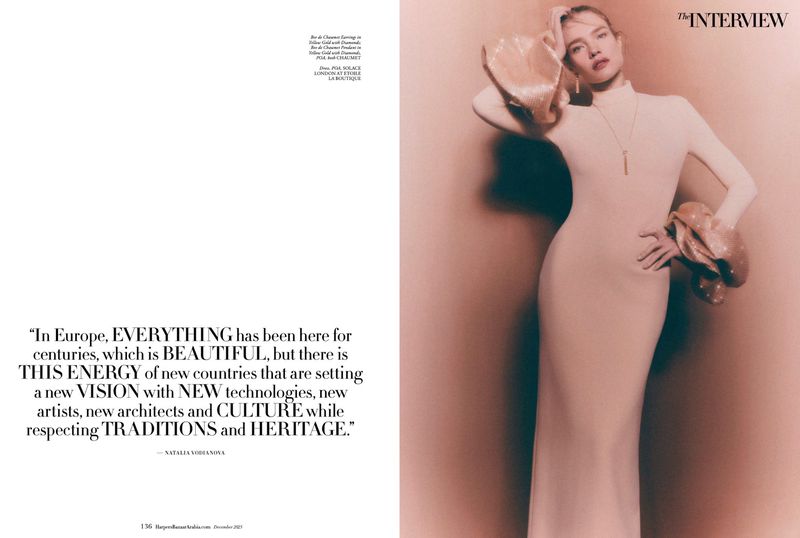 Natalia Vodianova posing in a cream high-neck maxi dress with metallic ruffled cuffs in a Harper's Bazaar Arabia editorial spread.