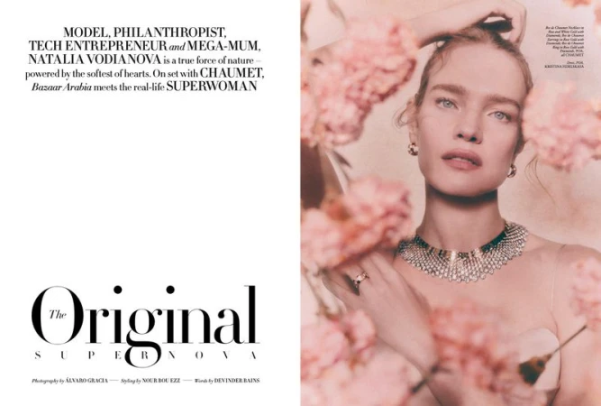 Magazine spread of Natalia Vodianova wearing a diamond collar necklace framed by soft pink flowers for Harper's Bazaar Arabia.
