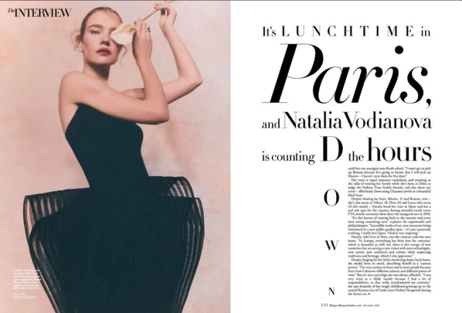 Natalia Vodianova poses in a strapless black dress with a white flower in front of her eye in a magazine editorial spread.