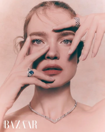 Natalia Vodianova posing with hands framing her face wearing a sapphire diamond ring and necklace for Harper's Bazaar Arabia.