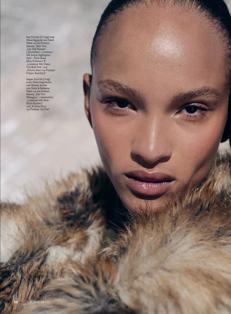 Portrait of a woman with tan skin wearing a fur coat. The photo features a shallow depth of field and muted earthy tones.