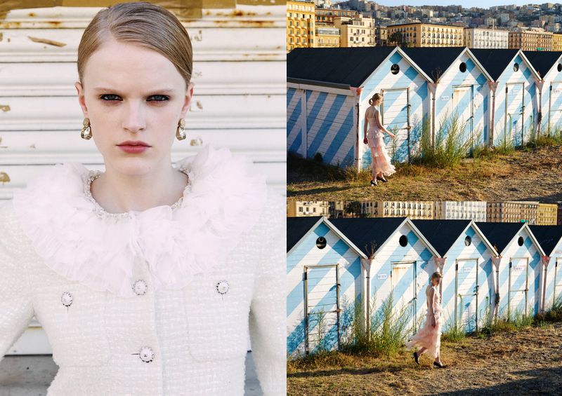 Fashion editorial shot: fair-skinned woman in a white jacket with a frilled collar, juxtaposed with a woman in a gown near beach huts.