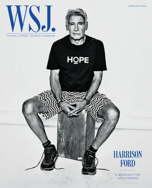 Harrison Ford poses for WSJ Magazine cover, seated on a box, wearing a black tee with the word 'HOPE' and patterned shorts.