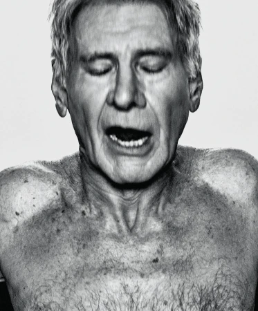 Black and white portrait of a mature adult man with closed eyes, mouth open, and torso visible against a plain white backdrop.