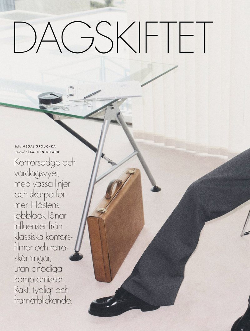 Fashion layout featuring a glass desk, a briefcase, and the lower half of a person in a suit, presenting a clean and professional style.