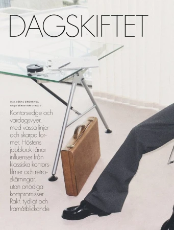 Fashion layout featuring a glass desk, a briefcase, and the lower half of a person in a suit, presenting a clean and professional style.
