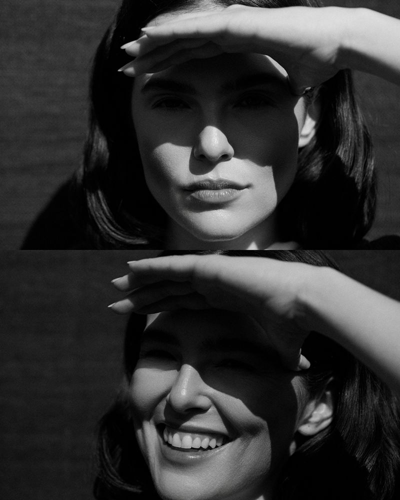 Black and white split portrait of Zoey Deutch shielding her eyes from direct sunlight with her hand, serious in one frame and smiling.