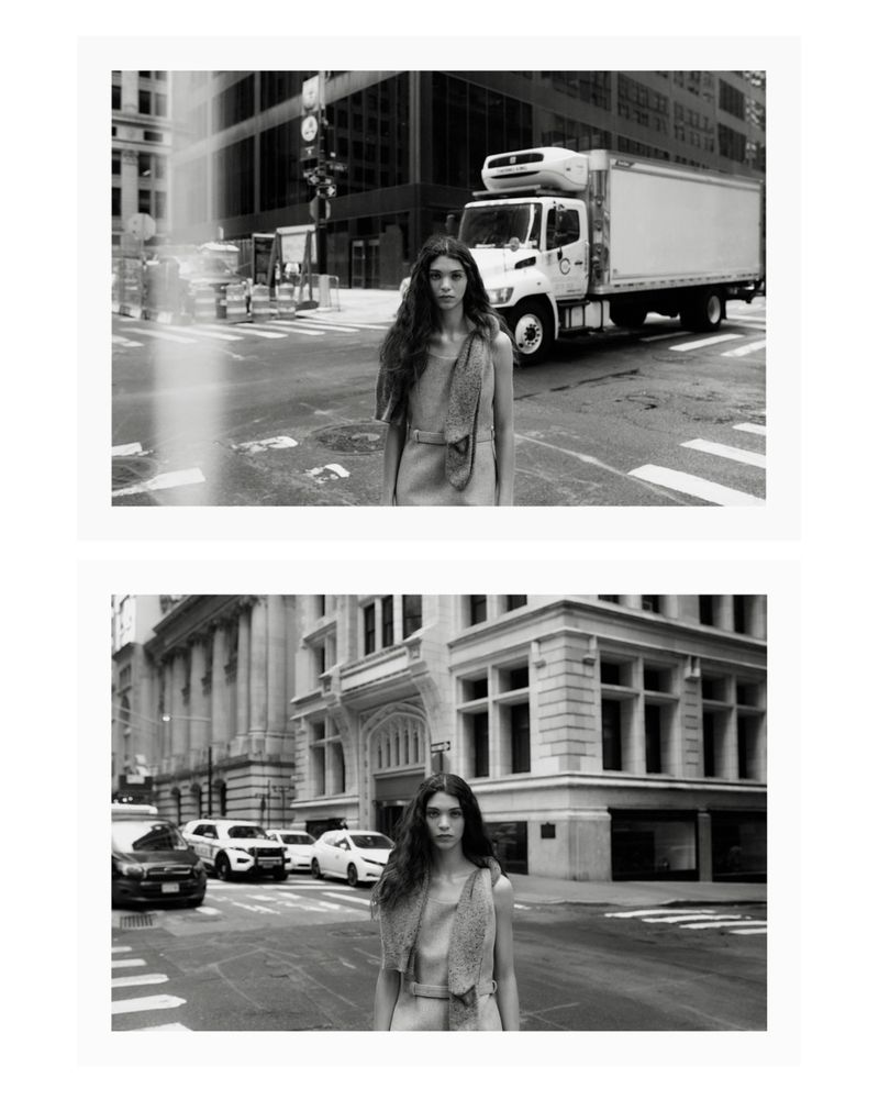 Black and white fashion portrait of a woman with long dark hair wearing a sleeveless dress, standing on a city street with buildings and cars.