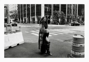 Model standing on a New York city street wearing a fur coat and tall boots for Vogue Polska NYC editorial