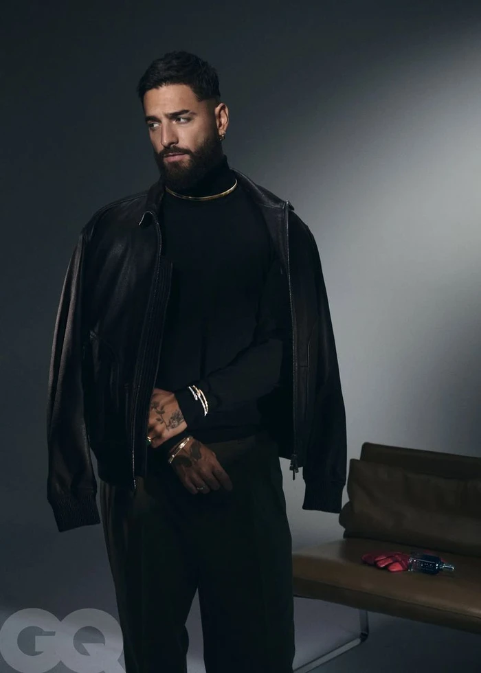 Maluma wearing a black turtleneck and leather jacket against a grey seamless studio backdrop for GQ Mexico