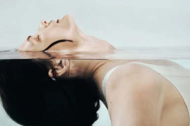 Model Lara Mullen submerged in water up to her chin, photographed by Nick Thompson for HardCOPY Magazine