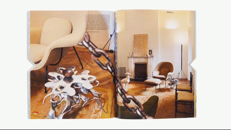 Open magazine spread displays modern chair and table designs, alongside traditional interior showcasing furniture and fireplace.