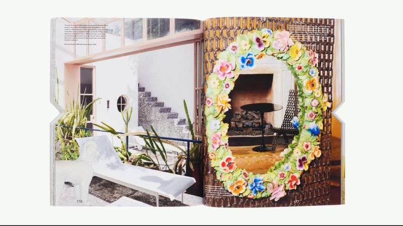 Magazine spread features an outdoor patio with a white lounge chair and a floral wreath over a fireplace with black table and chair.