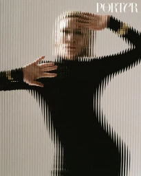 Cate Blanchett wearing a black long-sleeve top behind vertically striped fluted glass for Porter Magazine editorial