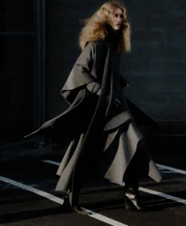 Model Apolline Rocco Fohrer wearing a grey coat and boots outdoors by Sonia Szostak