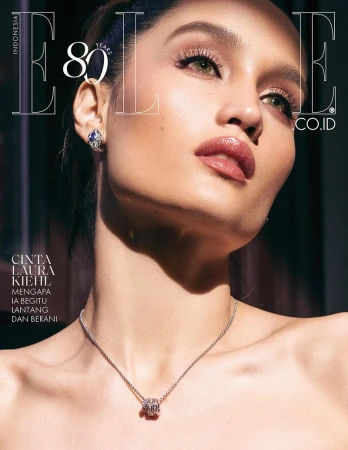Close-up portrait of Cinta Laura Kiehl wearing a silver pendant necklace and earrings for Elle Indonesia