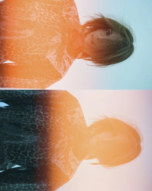 Portrait of a woman with short brown hair wearing a leopard-print top with an orange and blue gradient background in an eye-level shot.