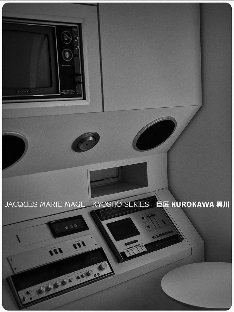 Retro-futuristic console featuring a vintage television, audio equipment, and circular architectural details, presented in a high-contrast monochrome.