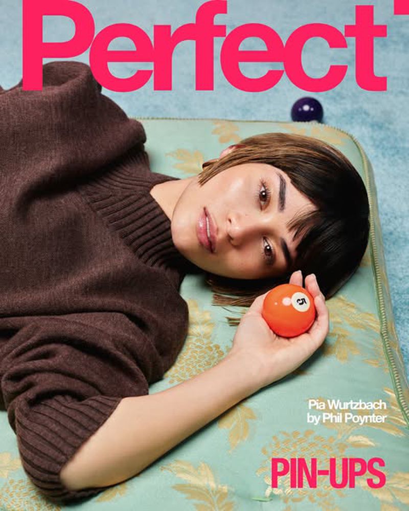 Magazine cover featuring Pia Wurtzbach, photographed by Phil Poynter. Wurtzbach is lying on a floral patterned surface holding a ball.