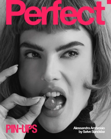 Close-up studio shot of Alessandra Ambrosio on a magazine cover, holding a cherry near her mouth, with bold text and graphic design elements.