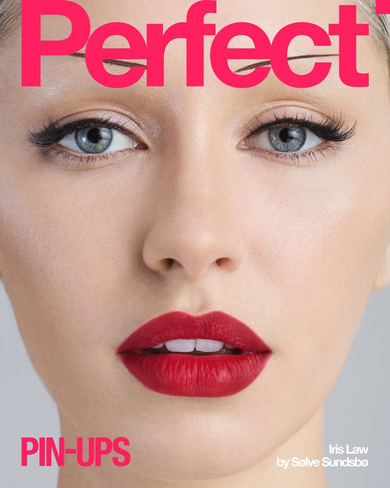 Close-up magazine cover featuring a fair-skinned woman with red lips, blue eyes, and the word 'Perfect' in pink text at the top.