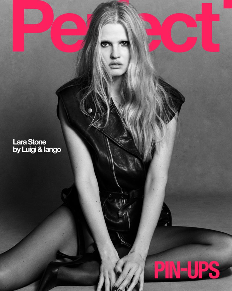 Lara Stone wearing a dark leather vest and black tights against a grey studio background for The Perfect Magazine.