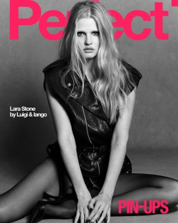Lara Stone wearing a dark leather vest and black tights against a grey studio background for The Perfect Magazine.