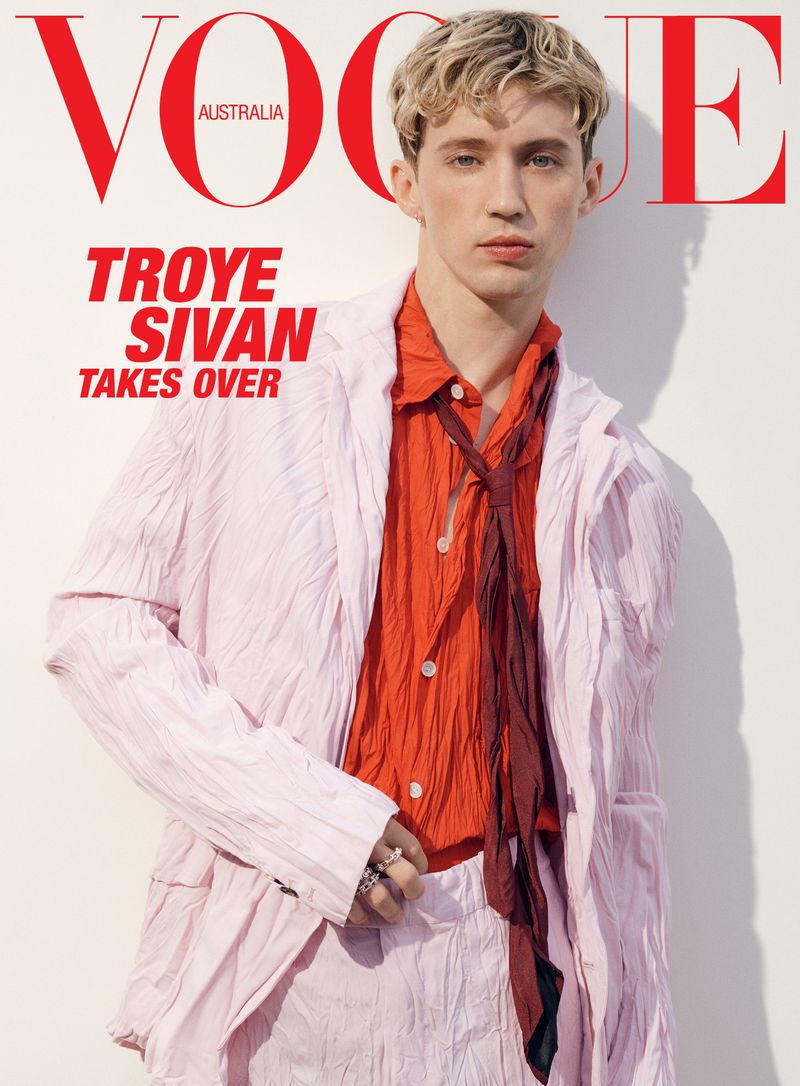 Vogue Australia magazine cover featuring Troye Sivan in a pink suit and coral shirt against a white background.