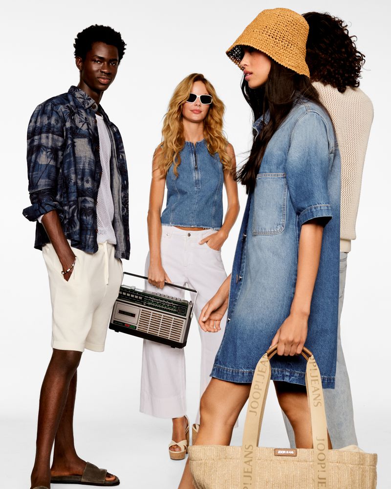 Four diverse fashion models showcasing casual summer apparel in a studio shot with bright lighting. One carries a retro boombox.