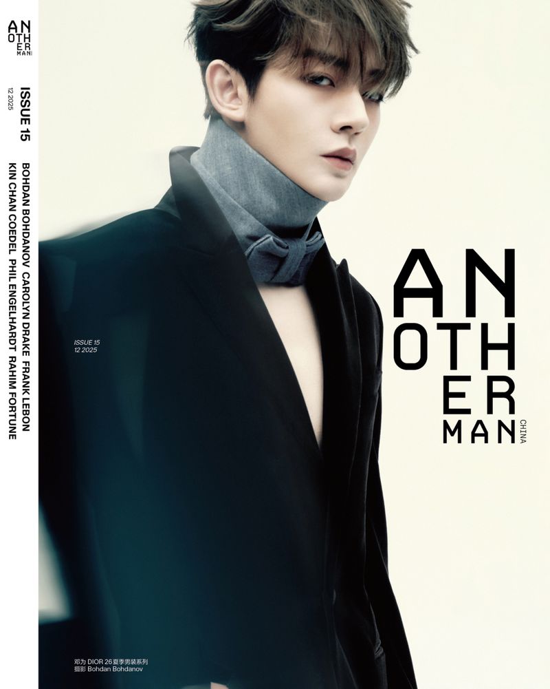 Magazine cover featuring a stylish adult male with dark hair wearing a unique grey neckpiece and black suit against a neutral background.