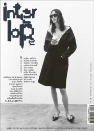 Alexa Chung wearing dark sunglasses and an off-the-shoulder black coat while holding a coffee cup on the Interlope Magazine cover.