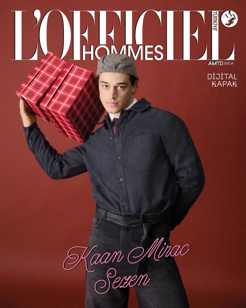 Magazine cover features a stylish man holding a gift box, in a studio setting with a solid red background and prominent magazine text.