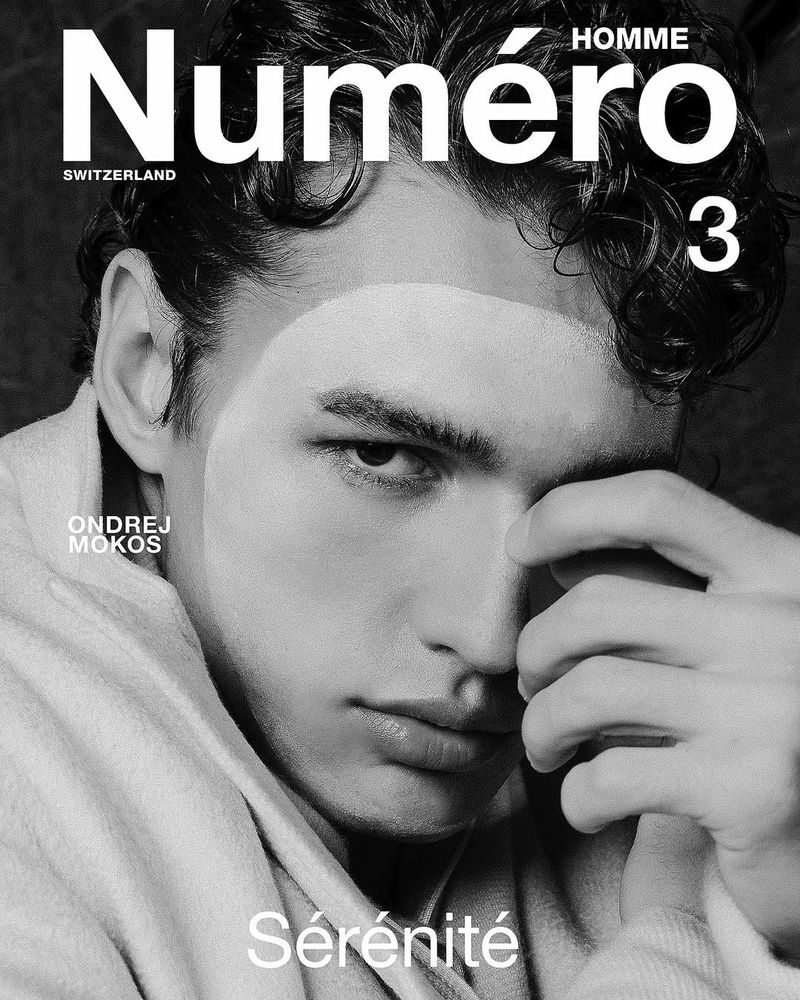 Black and white portrait of a man on a magazine cover, wearing a light-colored robe and touching his face, featuring the magazine's title.