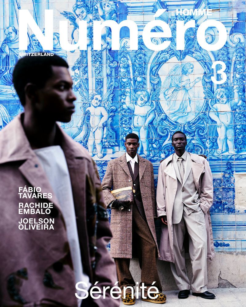 Magazine cover featuring three Black male models in stylish overcoats against a blue tiled backdrop, highlighting high fashion and serene aesthetics.
