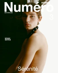 Shirtless model Noah Bates wearing a black beaded necklace on the cover of Numéro Homme Switzerland issue 3.