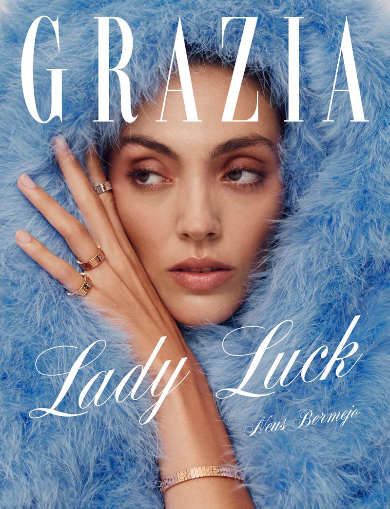 Grazia magazine cover featuring a woman with fair skin, light brown hair, and light brown eyes, framed by a feathery light blue hood.