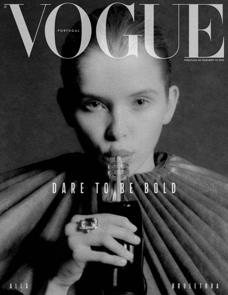 Vogue Portugal cover featuring a fair-skinned person drinking from a glass bottle with a straw against a dark gray backdrop.