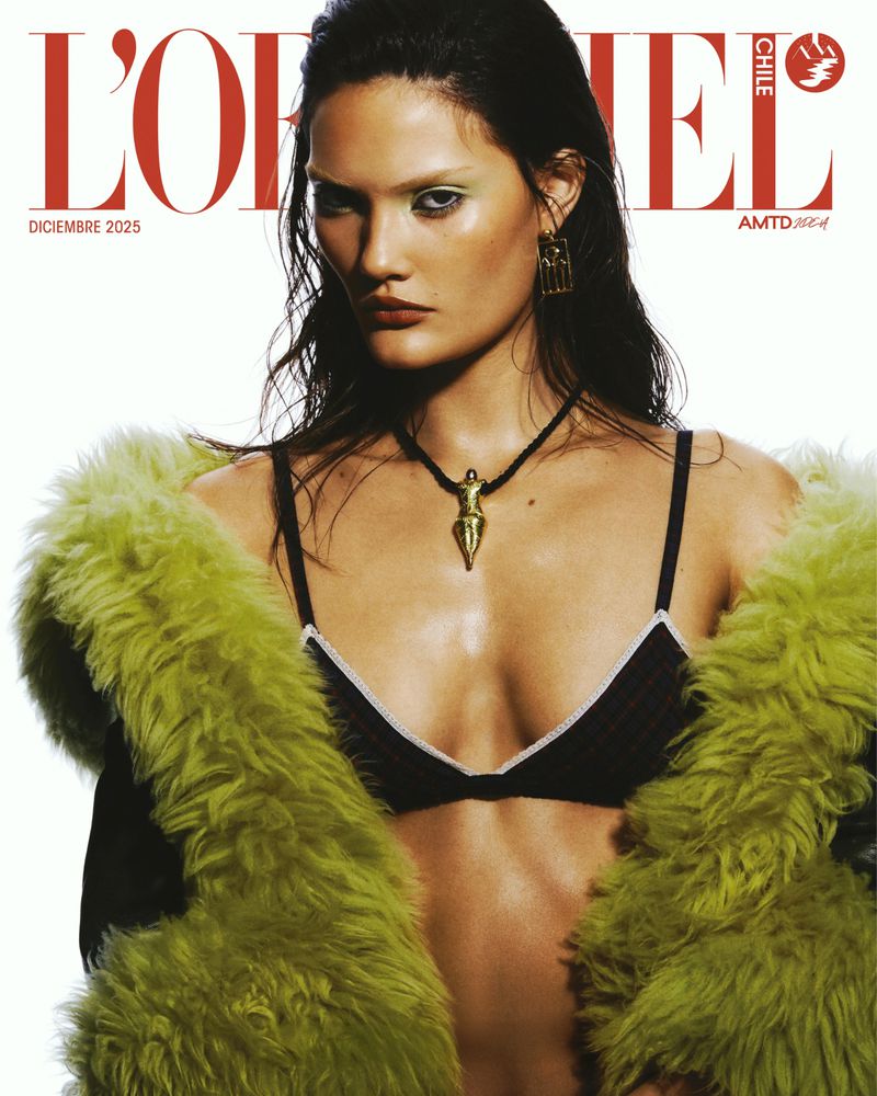 Magazine cover featuring a model wearing a black bra, gold pendant, and a green fur coat, with the magazine's logo in red text.