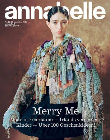 Model Julia Rambukkana wearing an ornate multi-colored tassel jacket and black skirt on the cover of Annabelle Magazine.