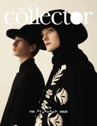 Two models in profile wearing black hats and black coats with white botanical embroidery for The Collector Magazine.