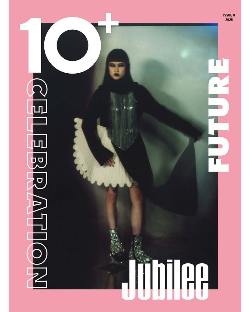Fashion magazine cover featuring a stylish woman in a black outfit with a silver top and sparkly boots, set against a silver background.