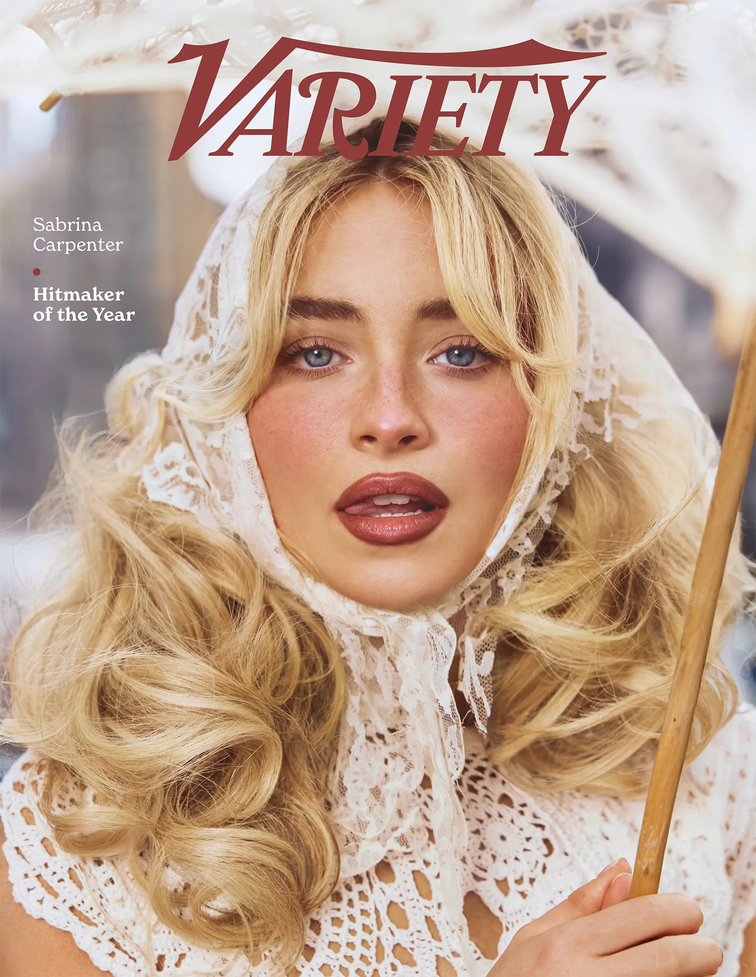 Sabrina Carpenter cover photo for Variety, posing with lace headscarf and patterned white dress holding a white parasol.