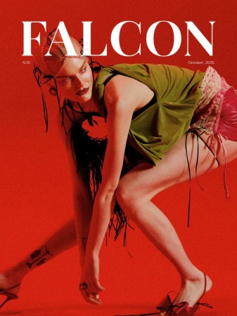 Model Lily Chapman in an olive green top and pink shorts crouching against a solid red backdrop on the Falcon Magazine cover.