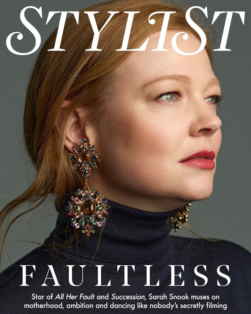 Sarah Snook on the cover of Stylist magazine, wearing statement earrings and a dark turtleneck sweater, close-up studio portrait.