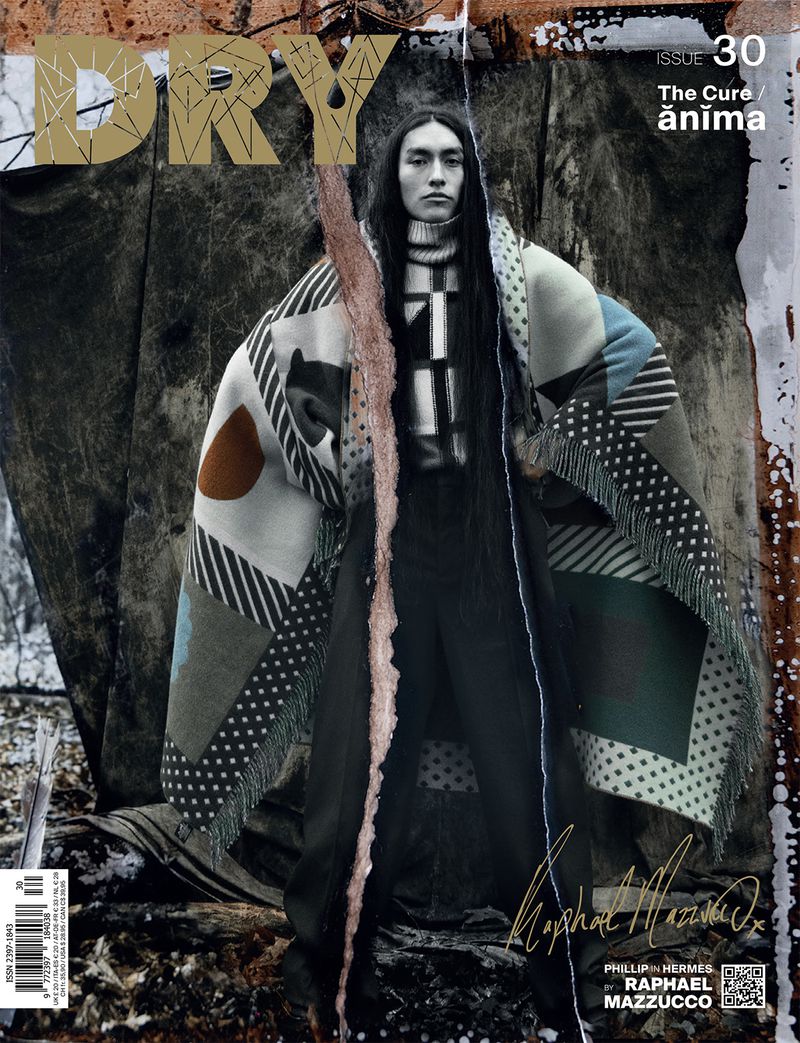 Magazine cover featuring an Asian male model wearing a patterned coat, posing with a stick against a grungy, textured backdrop with 'DRY' logo.